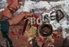 Detail of a sculptural collage combining a woman from an advertisement, torn layers and a round metal object.
