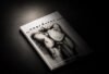 Anecdotes Issue 04, Nua Collective’s Autumn 2026 art publication, displayed on a dark surface.