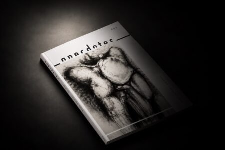 Anecdotes Issue 04, Nua Collective’s Autumn 2026 art publication, displayed on a dark surface.